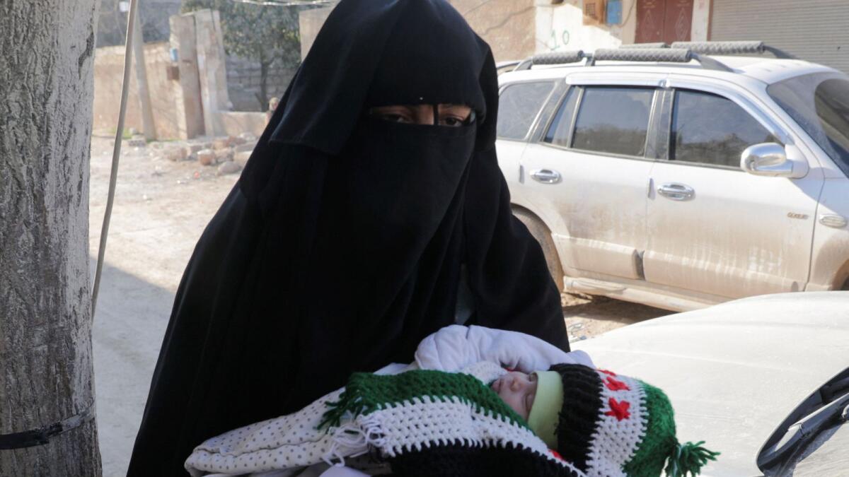 Hala, the paternal aunt of a baby girl who was born during a deadly earthquake earlier this month, is reunited with her, in the rebel-held town of Jandaris, Syria, on Saturday. — Reuters