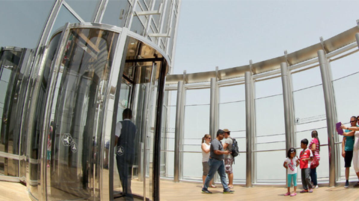 High up in the air: Visitors at the open-air observatory deck on 148 floor of the Burj Khalifa.