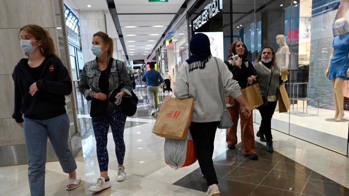 People walk in a shopping mall as retail businesses reopen to the public in Sydney. – AFP