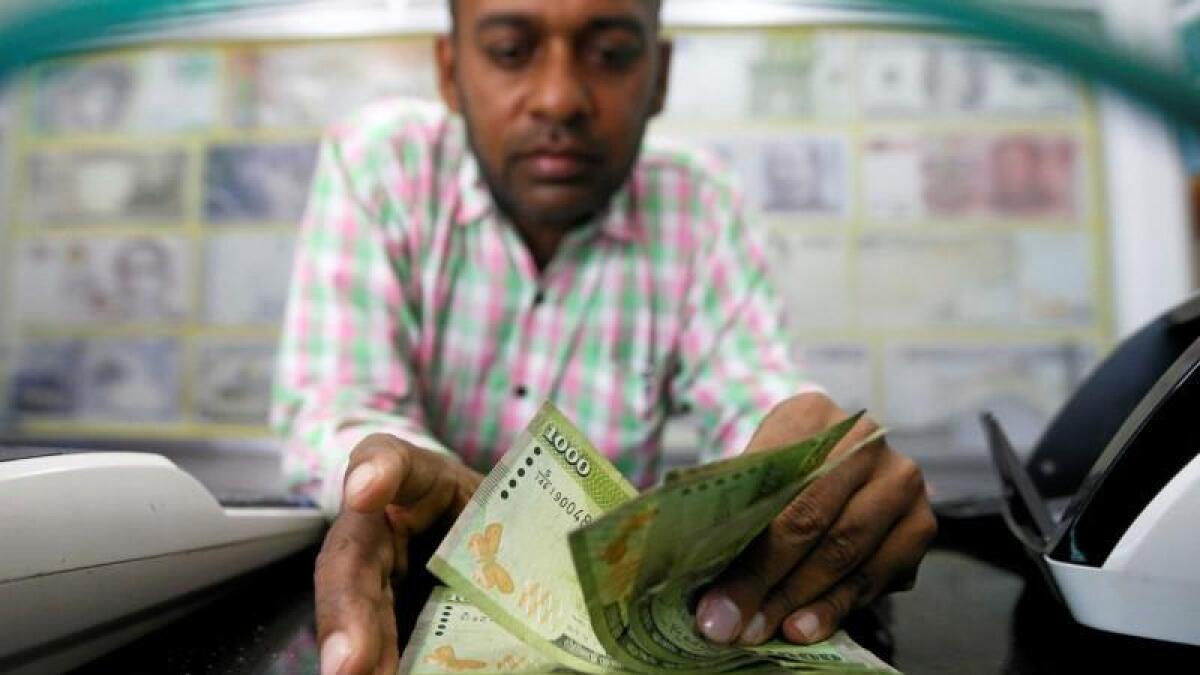 Wait or remit money back home? Sri Lankan rupee free fall may continue
