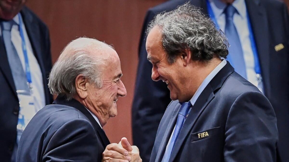 Sepp Blatter (left) is congratulated by Michel Platini after being re-elected in 2015. - AFP file