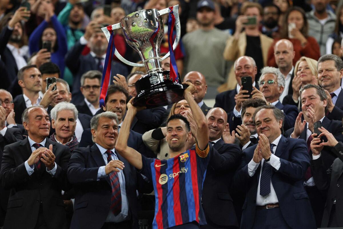 Barcelona's Sergio Busquets lifts the La Liga trophy. — AFP