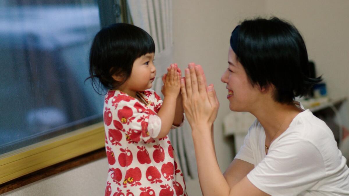 This photo provided by Japan Media Services shows a scene from The Ones Left Behind: The Plight of Single Mothers in Japan, directed by Rionne McAvoy. — AP