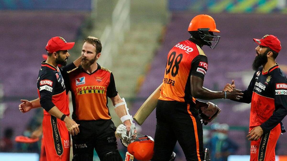 Virat Kohli and Moeen Ali greet Kane Williamson and Jason Holde after the Eliminator. — IPL
