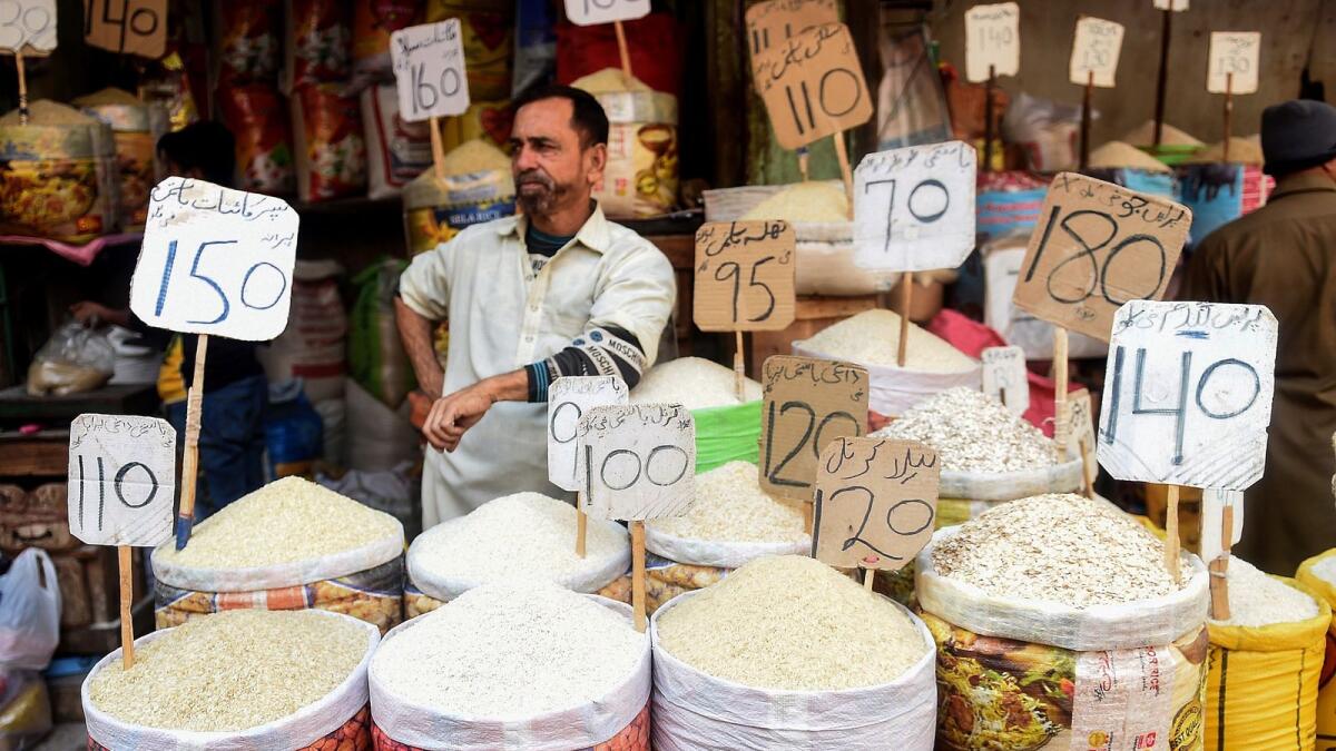 A shopkeeper waits for customers at a market in Karachi. Shaukat Tarin said commodity prices in international markets are on the rise, and the government is making all-out efforts to minimise its impact on common man.