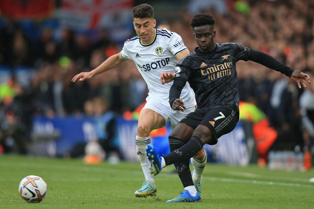 Leeds United's Marc Roca (left) vies with Arsenal's Bukayo Saka. (AFP)