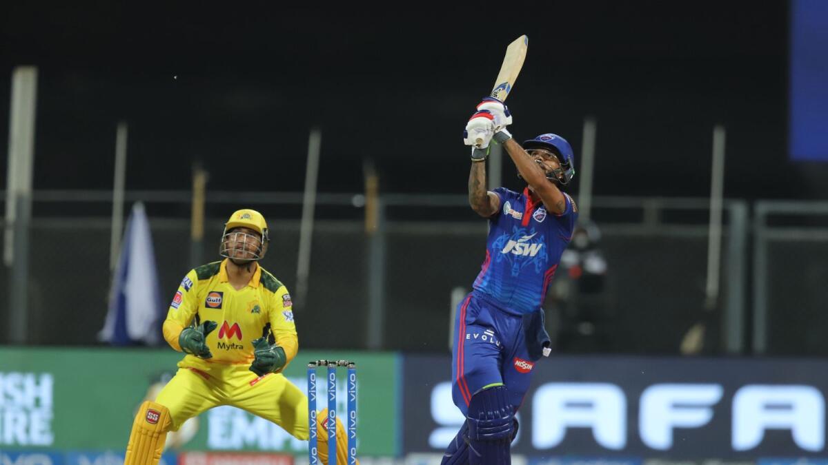 Shikhar Dhawan of Delhi Capitals hits a boundary as MS Dhoni looks on. — IPL
