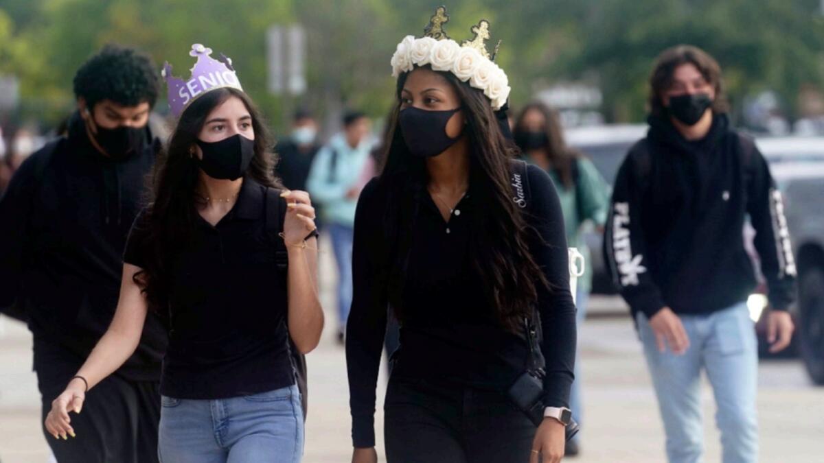 Students at Barbara Coleman Senior High School in Miami Lakes wear masks on their first day of school. — AP