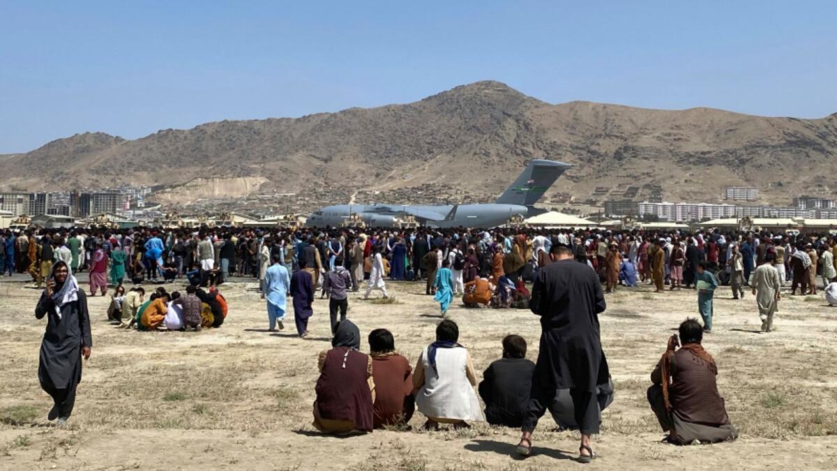 Hundreds of people gather near a US Air Force plane at the perimeter of the international airport in Kabul. Photo: AP