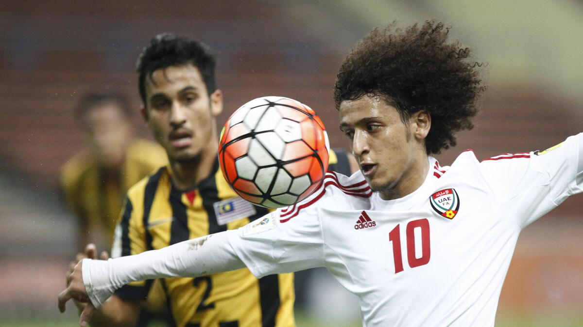 Omar Abdulrahman, right, of the United Arab Emirates vies for possession against Malaysia's Matthew Davies during the Group A World Cup 2018 qualifying soccer match in Shah Alam, Malaysia on Tuesday, Nov. 17, 2015. (AP Photo/Joshua Paul)