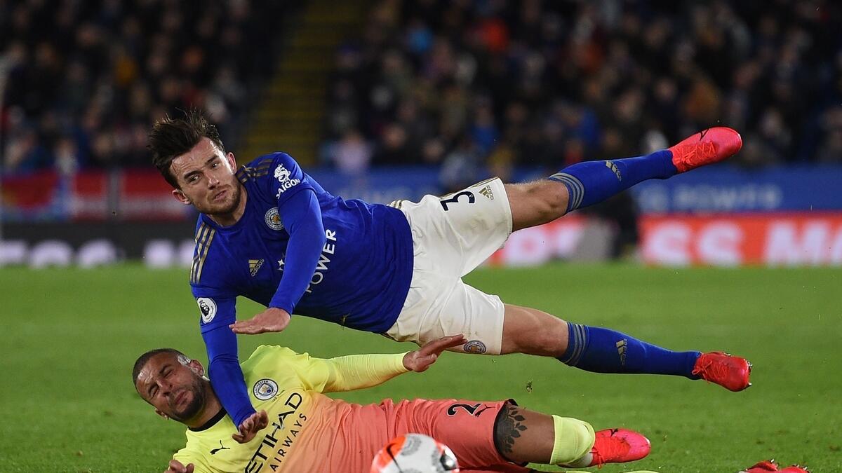 Manchester City's English defender Kyle Walker vies with Leicester City's English defender Ben Chilwell (up) during the English Premier League match