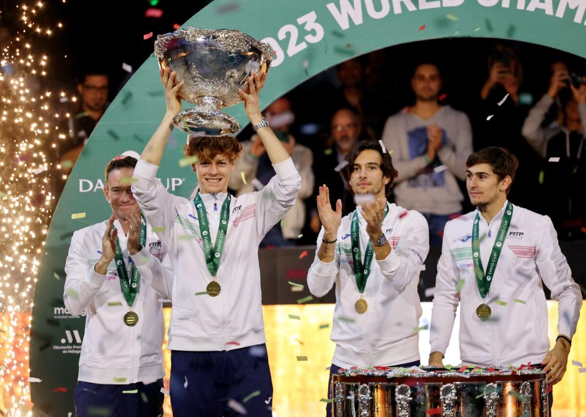 Italy's Jannik Sinner celebrates with the trophy and teammates after winning the Davis Cup. — Reuters