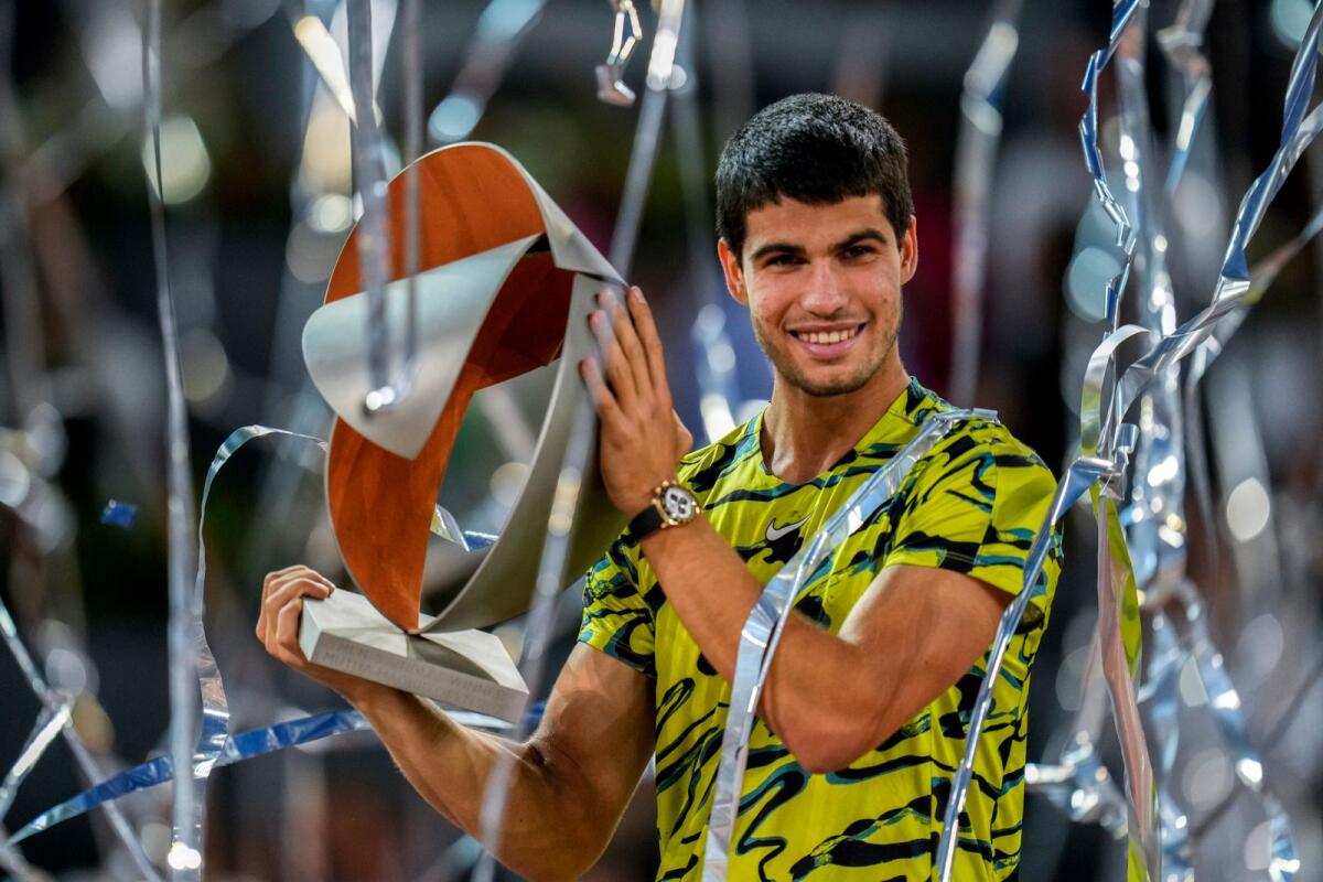 Carlos Alcaraz, of Spain celebrate with the winner's trophy after defeating Jan-Lennard Struff, of Germany, in the men's final at the Madrid Open on Sunday. — AP