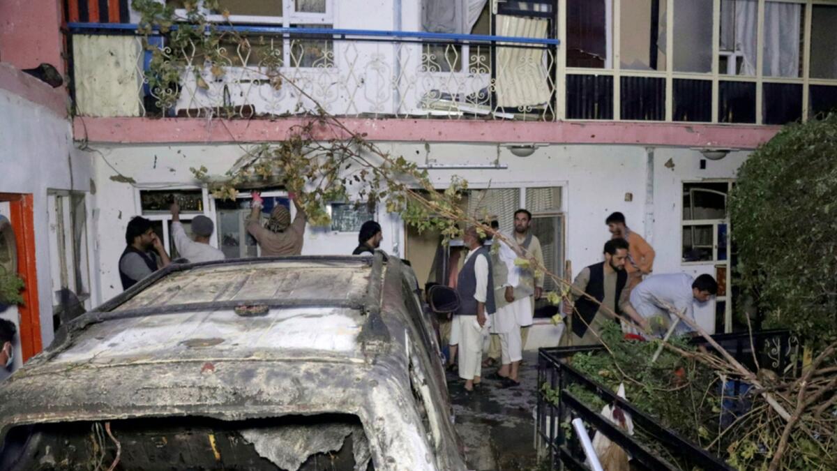 Afghan people are seen inside a house after US drone strike on a vehicle in Kabul. — AP