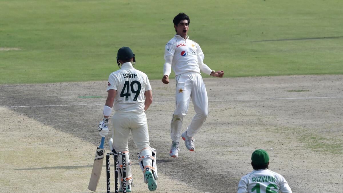Pakistan's Naseem Shah (centre) celebrates after taking the wicket of Australia's Steve Smith (left) during the first day of the third Test. (AFP)