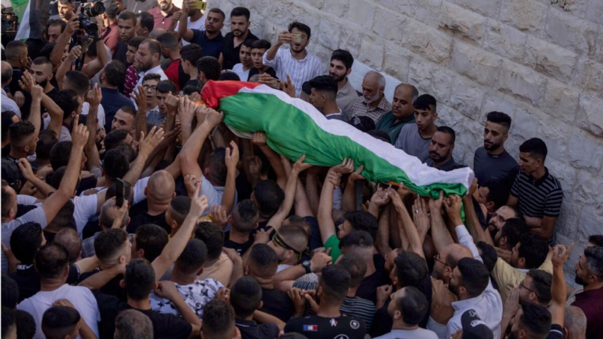 Mourners carry the body of Salah Sawafta during his funeral in the West Bank city of Tubas. — AP