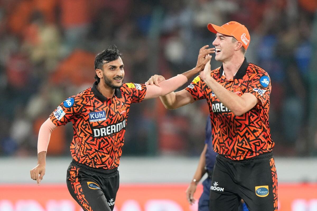 Sunrisers Hyderabad captain Pat Cummins (right) and Shahbaz Ahmed celebrate the dismissal of Mumbai Indians' Ishan Kishan. — AP
