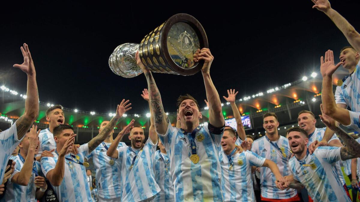 Argentina's Lionel Messi holds the trophy as he celebrates with teammates after winning the Conmebol 2021 Copa America. — AFP