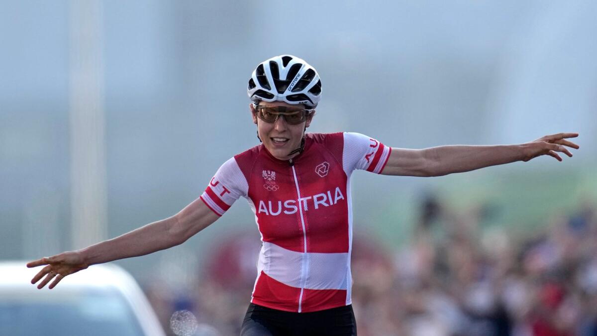 Anna Kiesenhofer of Austria, crosses the line to win the gold medal in the women's cycling road race. — AP