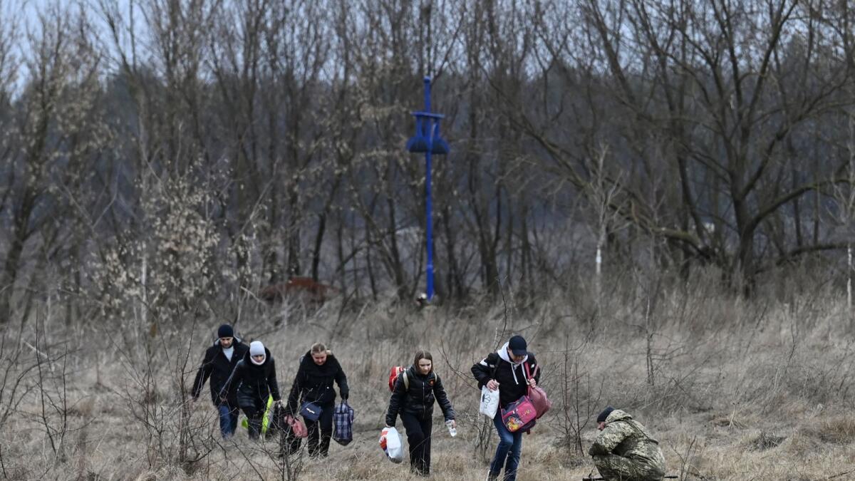 People flee the city of Irpin, west of Kyiv, on March 7, 2022. Photo: AFP