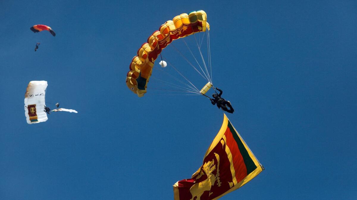 Sri Lanka's parachute jumpers take part during the country's 75th Independence Day celebrations in Colombo, Sri Lanka, on Saturday. — Reuters