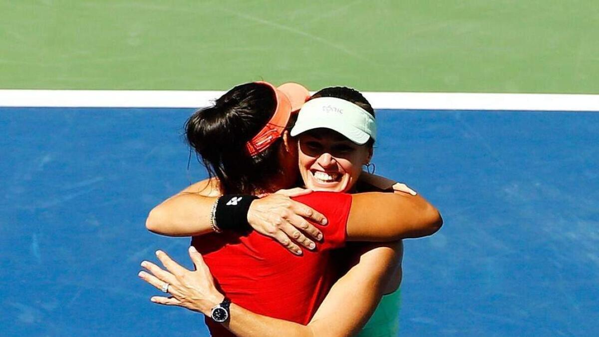 Sania Mirza of India (L) and Martina Hingis of Switzerland celebrate after winning the 2015 US Open women's doubles title at the U.S. Open Championships Tennis tournament in New York, September 13, 2015.  Reuters photo