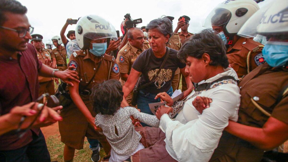 Police detain demonstrators during a protest against the Sri Lankan government in Colombo on October 9, 2022. — AFP file