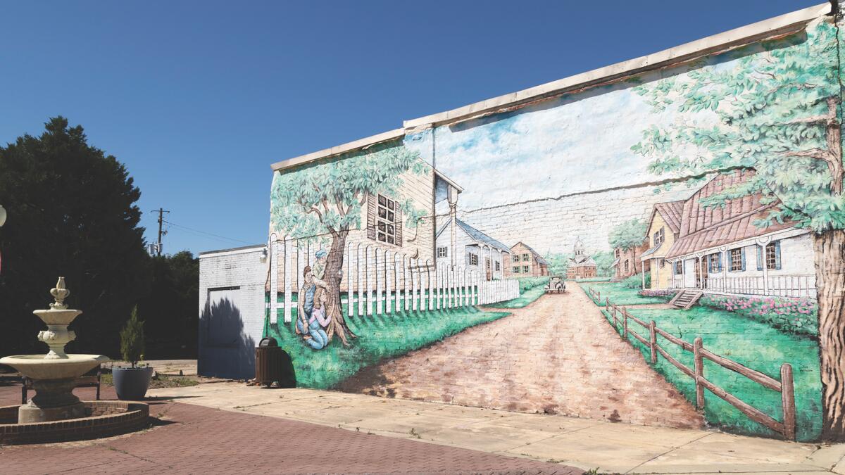 A mural depicting characters and houses from the novel To Kill a Mockingbird