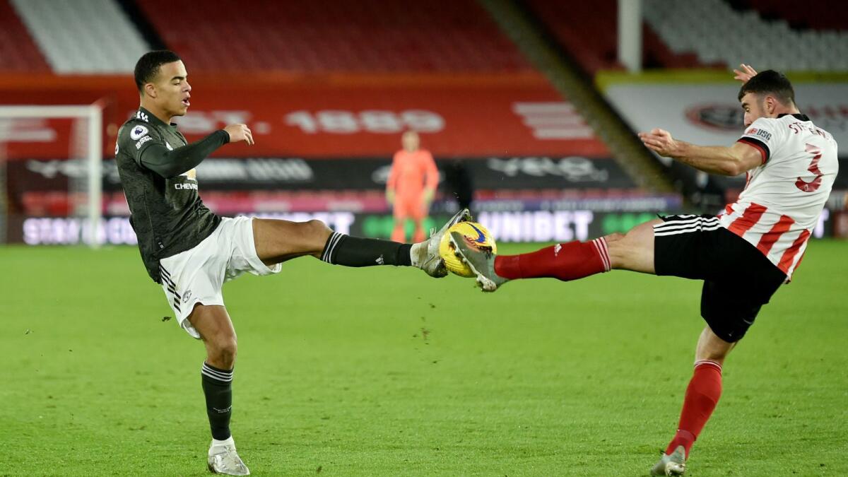 Manchester United's Mason Greenwood in action with Sheffield United's Enda Stevens.