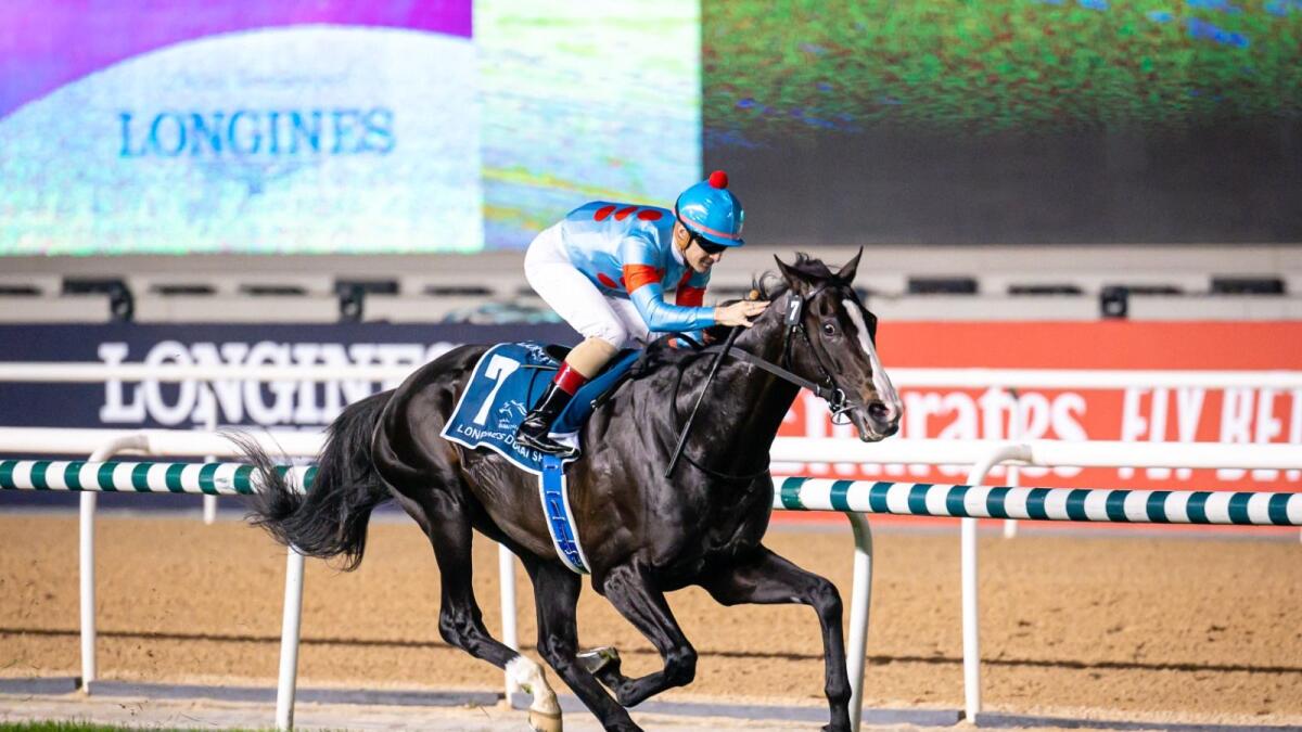 Japan's Equinox, ridden by Christophe Lemaire, races past the finish line to win the Longines Dubai Sheema Classic at the Meydan racecourse in Dubai on Saturday. — Photo by Neeraj Murali