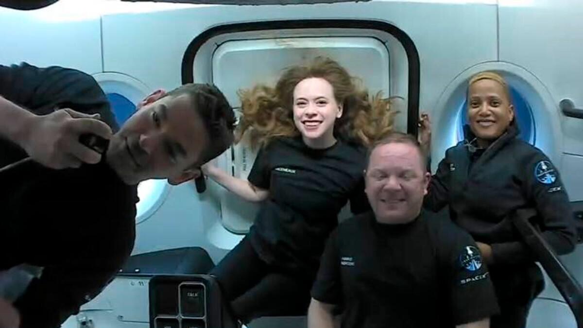 The passengers of Inspiration4 in the Dragon capsule on their first day in space. They are, from left, Jared Isaacman, Hayley Arceneaux, Chris Sembroski and Sian Proctor.