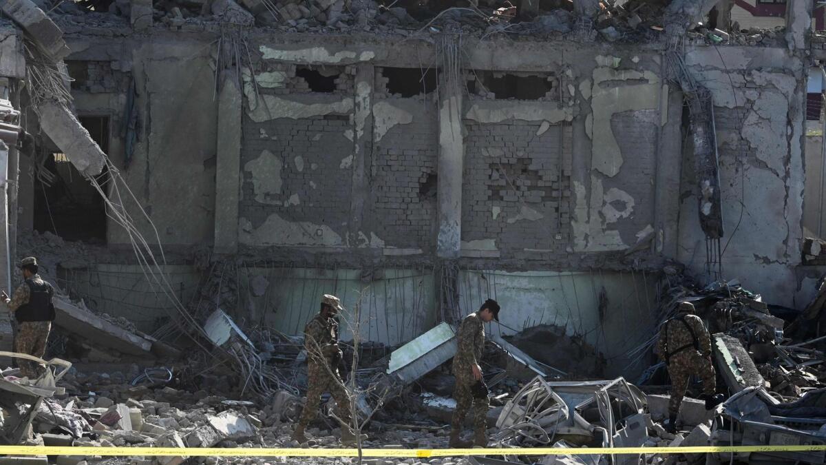 Security officials inspect the site a day after multiple explosions in a munitions cache levelled the specialist counter-terrorism police station in Kabal town of Swat Valley. — AFP