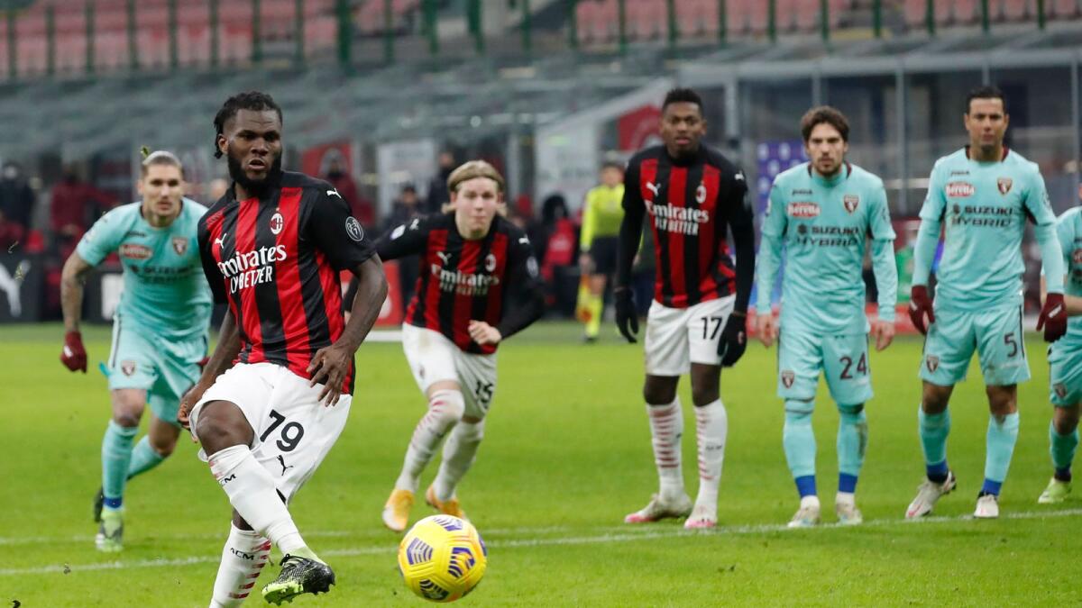 AC Milan's Franck Kessie (left) kick the ball and scores with penalty against Torino during the Serie A soccer match between AC Milan and Torino. — AP