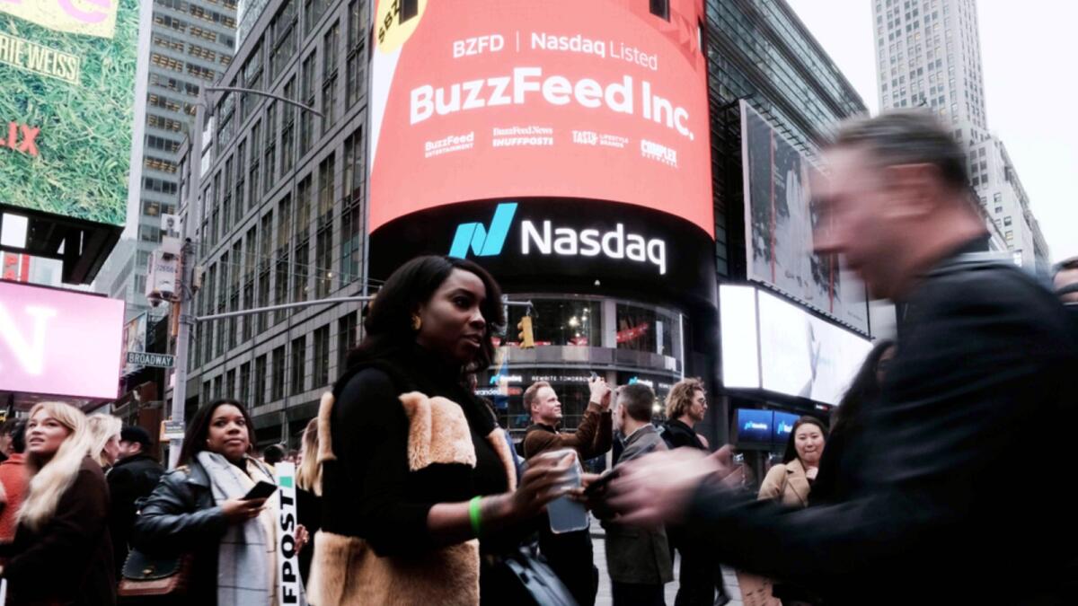 Employees of the media company BuzzFeed gather in front of the Nasdaq market site in Times Square. — AFP