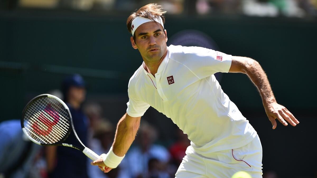 Switzerlands Roger Federer returns to Serbias Dusan Lajovic during their mens singles first round match on the first day of the 2018 Wimbledon Championships.- AFP