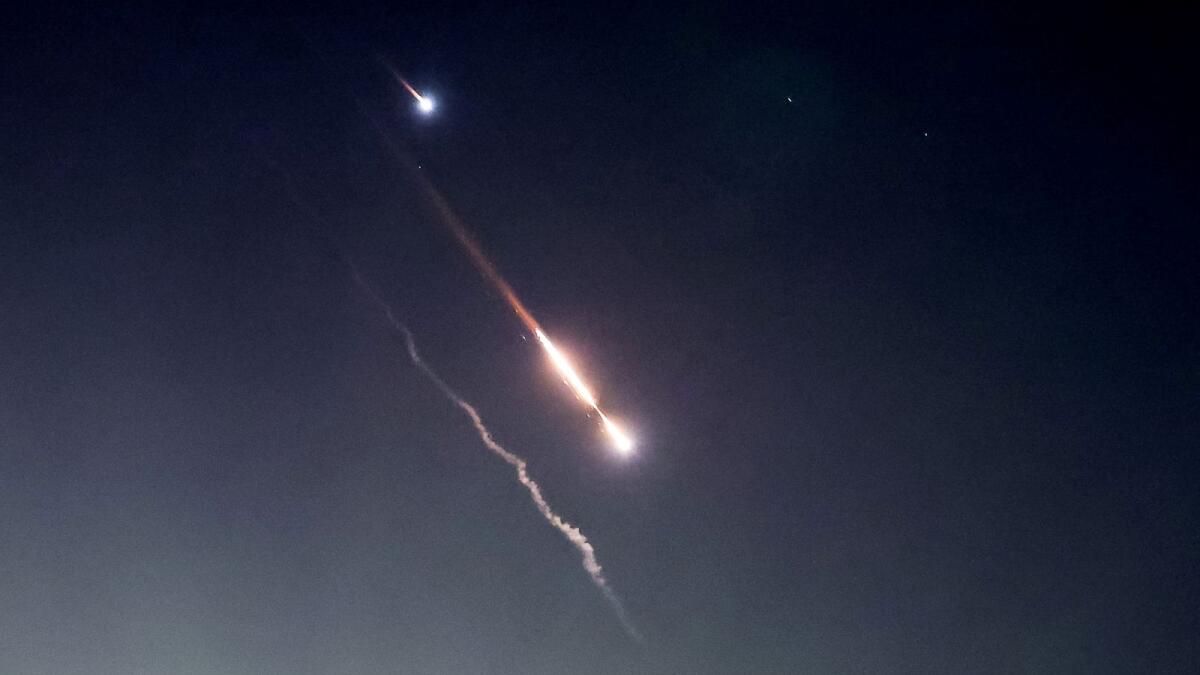 Objects are seen in the sky above Jerusalem after Iran launched drones and missiles towards Israel. Photo: Reuters