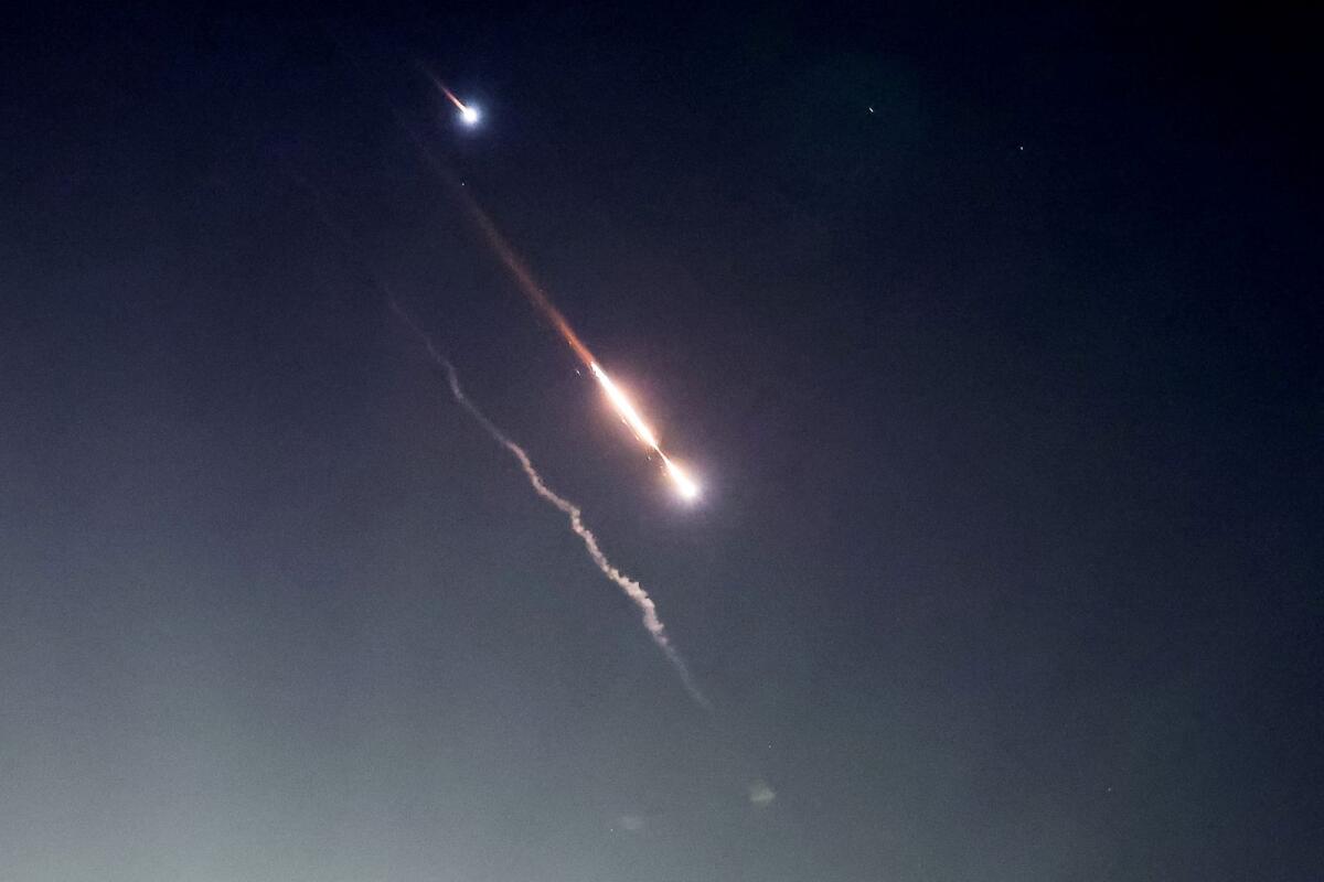 Objects are seen in the sky above Jerusalem after Iran launched drones and missiles towards Israel, in Jerusalem April 14, 2024. Photo: Reuters