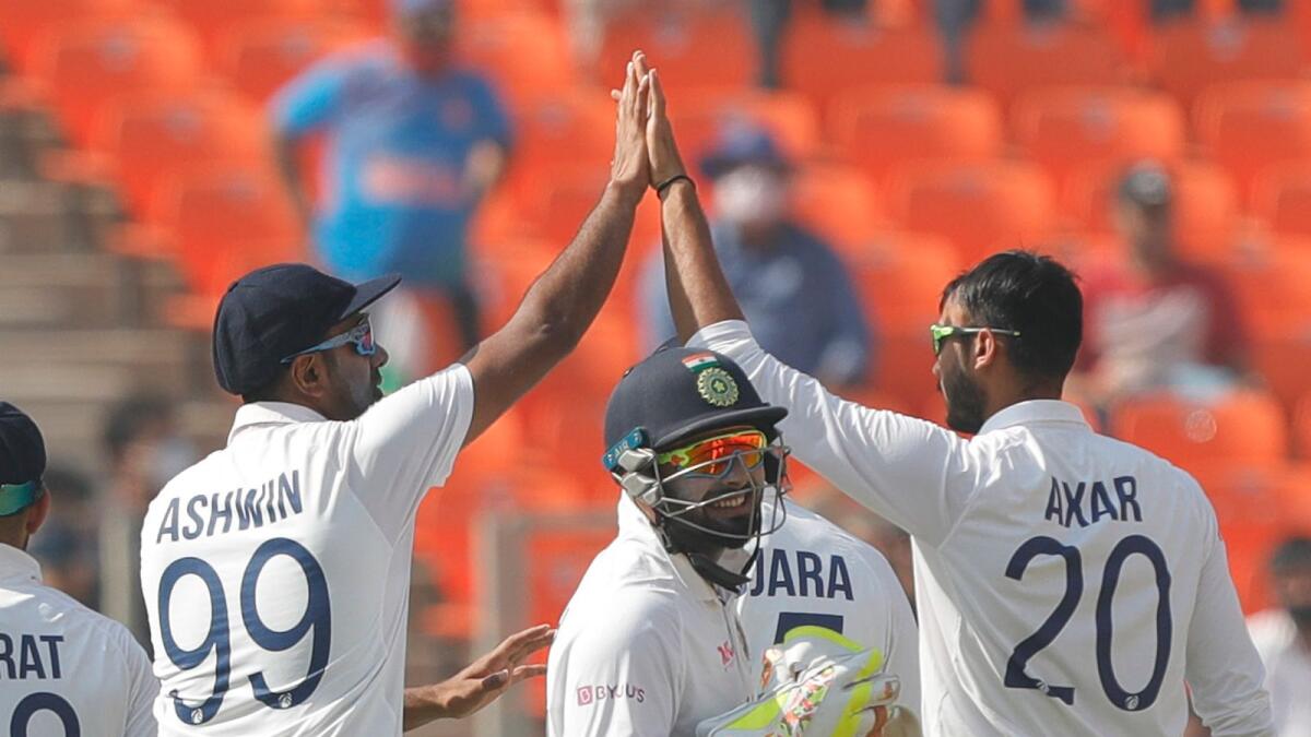 Axar Patel (right) of India celebrates a wicket with teammates during day one of the fourth Test. (BCCI)