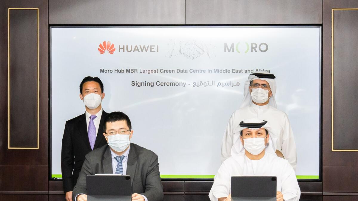 Haidar, vice-chairman and group CEO Digital Dewa, and Jerry Liu, CEO of Huawei UAE, signing the agreement while Saeed Mohammed Al Tayer, managing director and chief executive of Dewa, and Charles Yang, president of Huawei Middle East, look on. — Supplied photo