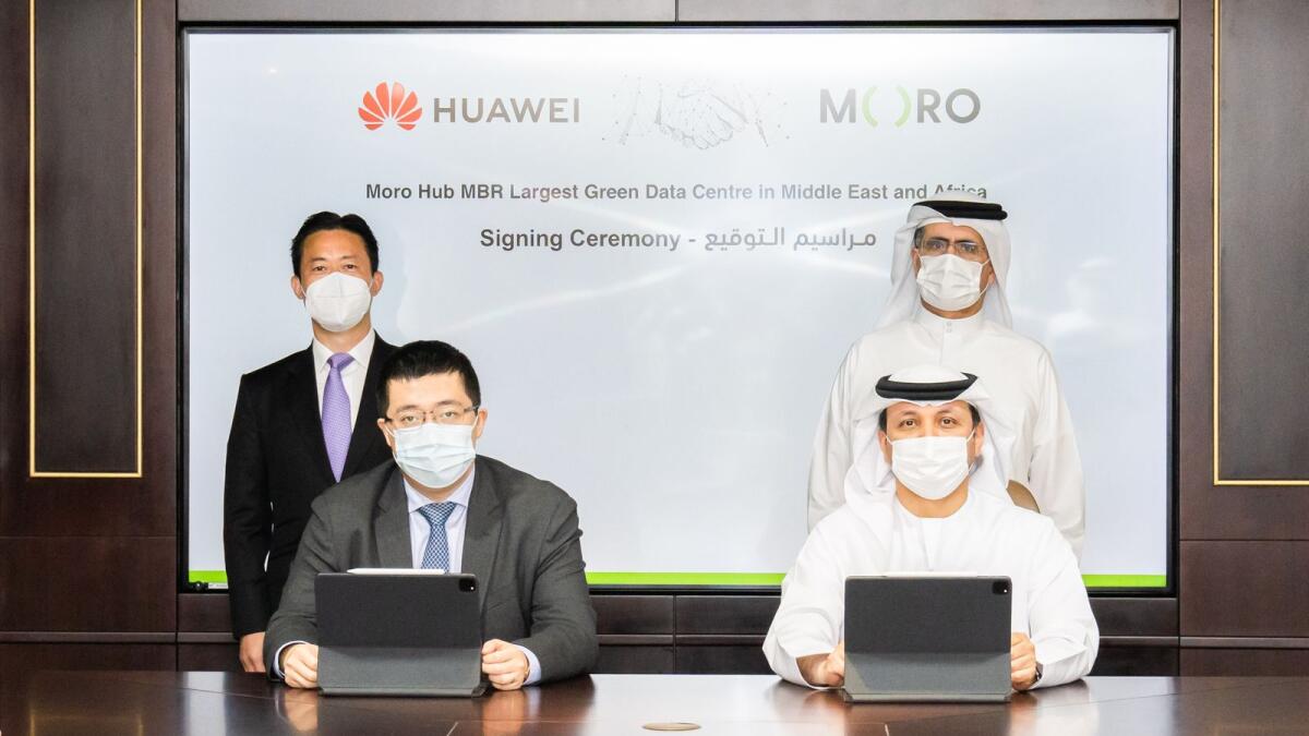 Haidar, vice-chairman and group CEO Digital Dewa, and Jerry Liu, CEO of Huawei UAE, signing the agreement while Saeed Mohammed Al Tayer, managing director and chief executive of Dewa, and Charles Yang, president of Huawei Middle East, look on. — Supplied photo