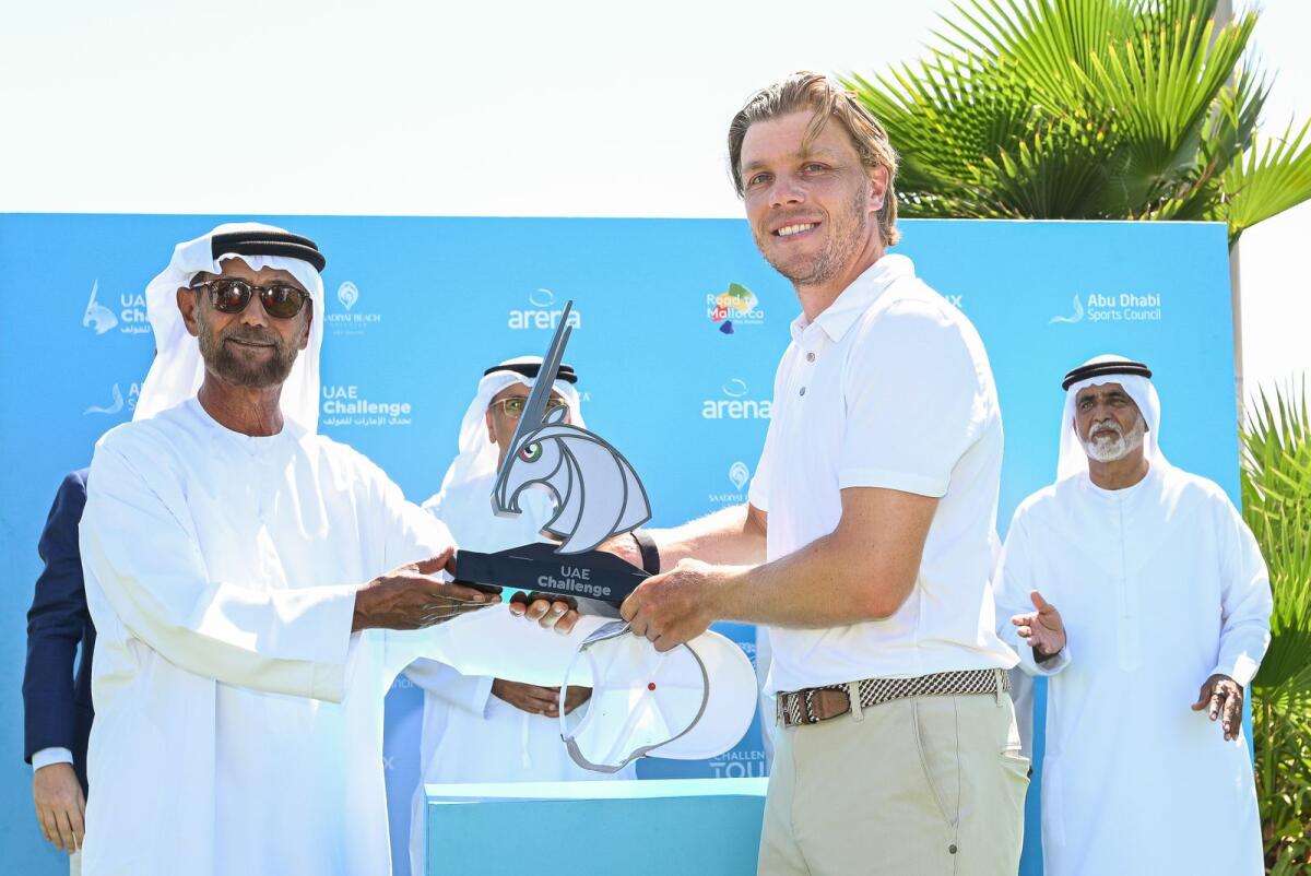 Shaikh Fahim bin Sultan Al Qasimi, chairman of the Emirates Golf Federation, presents the trophy to Maximilian Rottluff of Germany. — Supplied photo