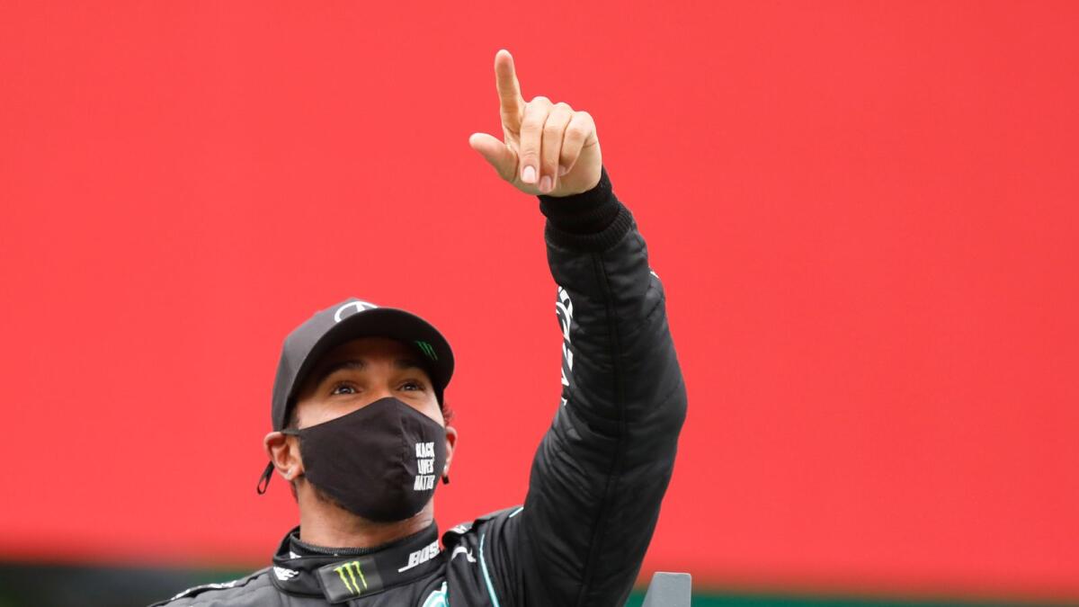 Mercedes driver Lewis Hamilton of Britain celebrates after winning the Formula One Portuguese Grand Prix.— AP