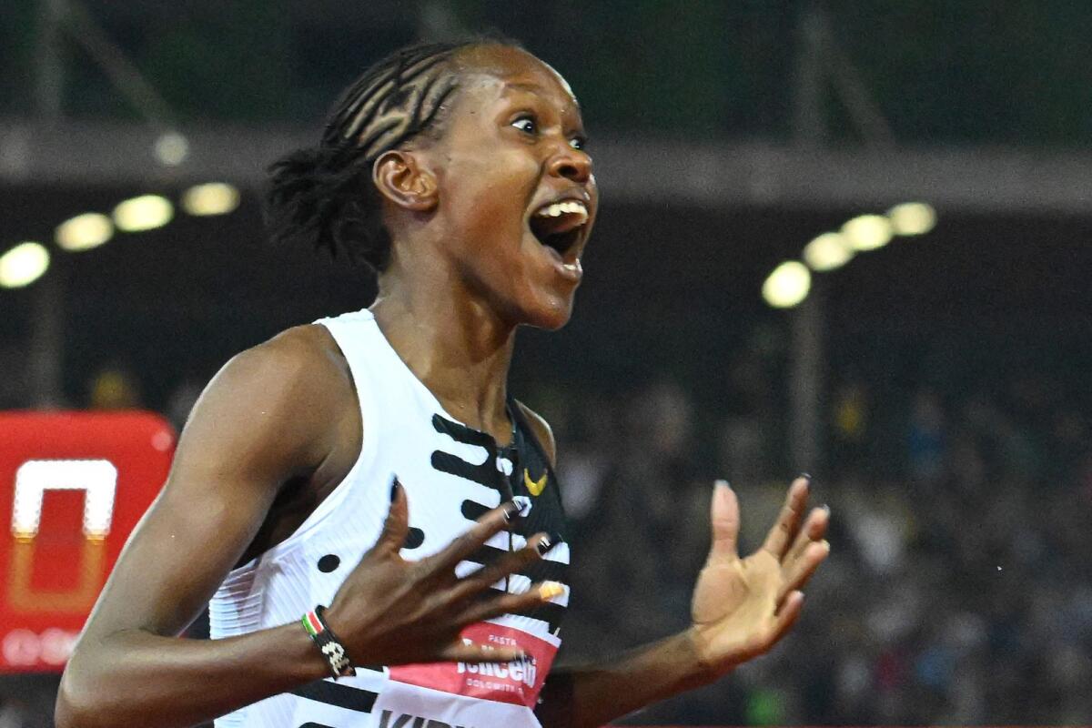 Kenya's Faith Kipyegon reacts as she wins the Women's 1500m event, setting a new world record of 3:49.11, during the Wanda Diamond League 2023 Golden Gala in Florence, Italy. - AFP