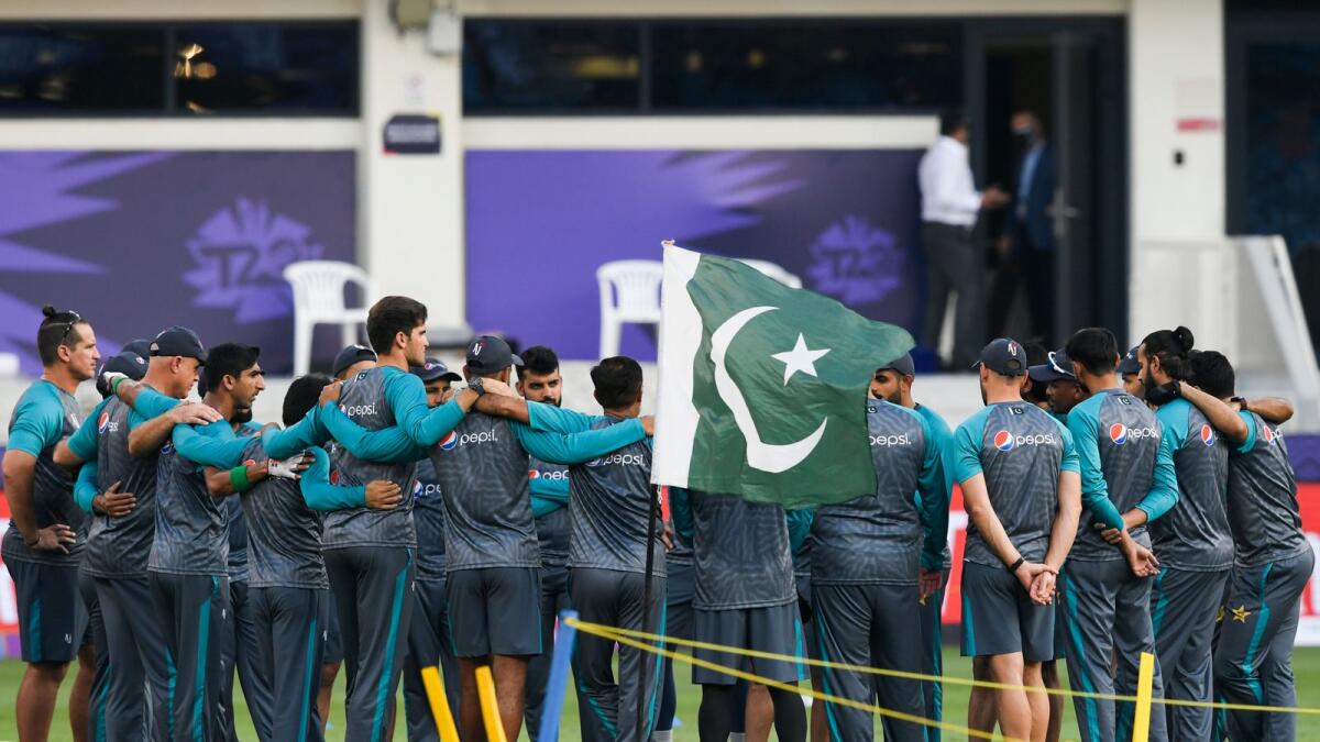 Pakistan's cricketers confer on the field before the start of the ICC men’s Twenty20 World Cup cricket match between India and Pakistan at the Dubai International Cricket Stadium in Dubai on October 24, 2021. (Photo: AFP)