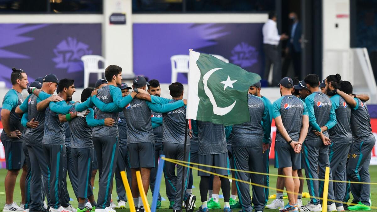 Pakistan's cricketers confer on the field before the start of the ICC men’s Twenty20 World Cup cricket match between India and Pakistan at the Dubai International Cricket Stadium in Dubai on October 24, 2021. (Photo: AFP)