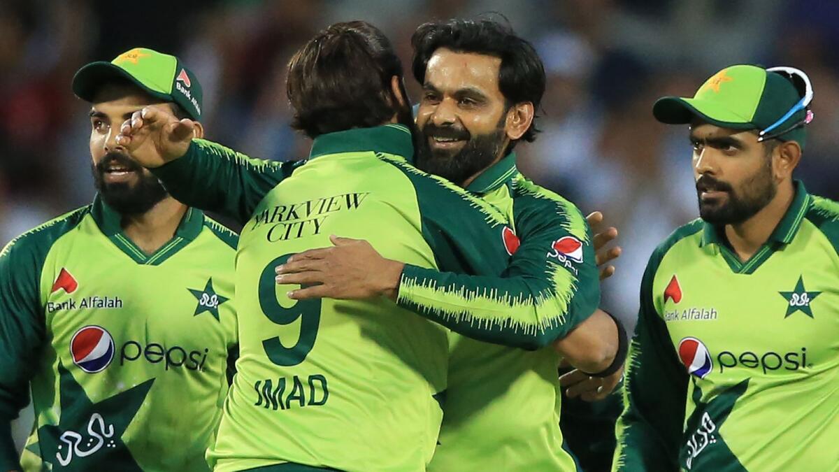 Pakistan's Mohammad Hafeez (centre) celebrates with teammates after taking the wicket of England's Moeen Ali during a T20 match on July 20, 2021. (AFP file)