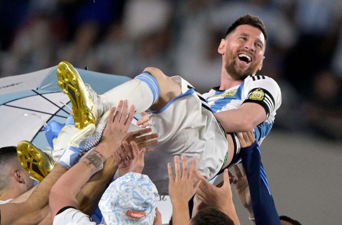 Argentina's forward Lionel Messi is lifted up by teammates during a recognition ceremony for the World Cup winning players, following the friendly match against Panama at the Monumental stadium in Buenos Aires. — AFP