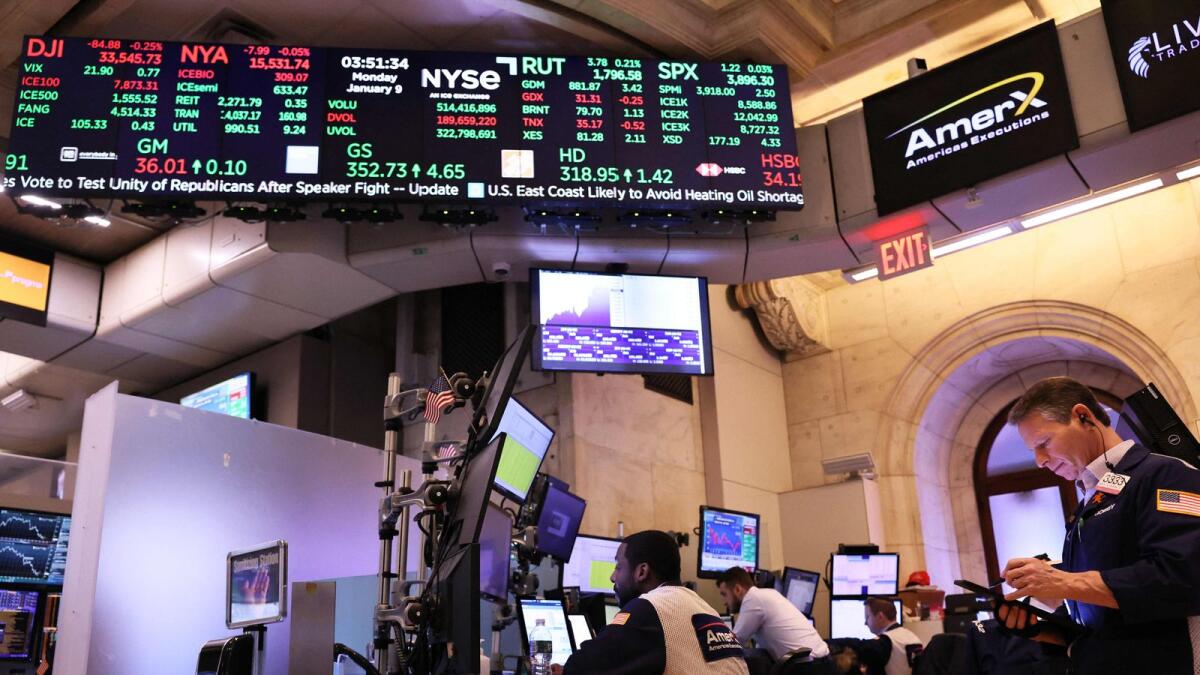 Traders work on the floor of the New York Stock Exchange. On Wall Street, equities were choppy after the data, with the S&amp;P 500 falling as much as 0.8 per cent before rebounding. - AFP