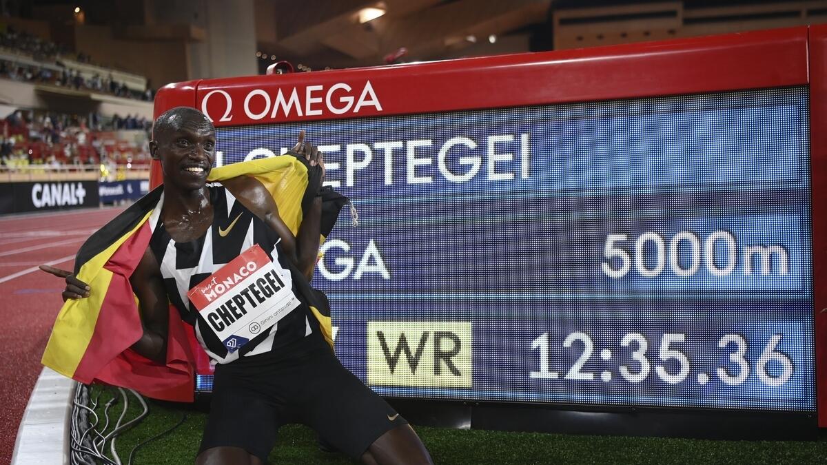 Uganda's Joshua Cheptegei celebrates after breaking the wold record in the men's 5000 meter final during the Diamond League athletics meeting in Monaco on Friday. (AP)