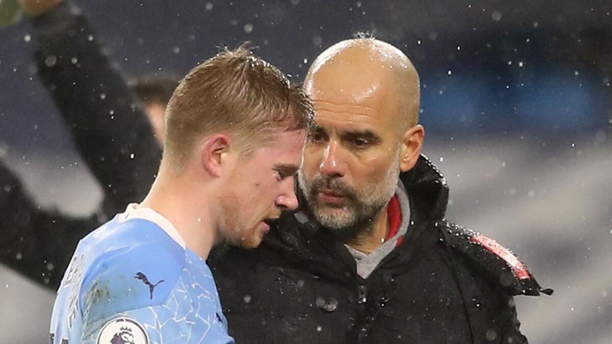 Kevin De Bruyne with Pep Guardiola after being substituted during the match against Aston Villa. — Reuters